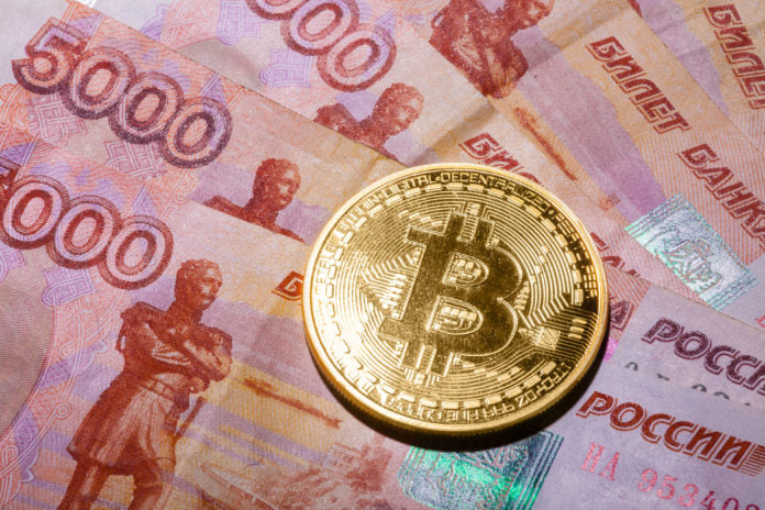 one bitcoin on russian rubles banknote