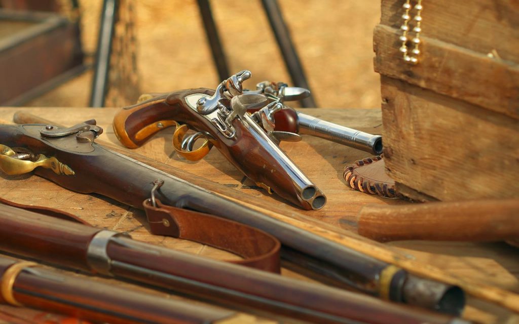 Picture of a collection of flintlock pistols and rifle muskets