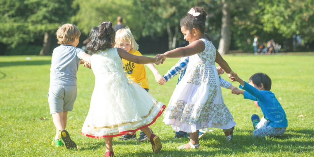 Children playing ring around the rosie